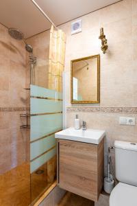 a bathroom with a sink and a shower at Golden Dune Apartment in Klaipėda