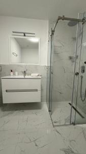 un bagno bianco con lavandino e doccia di Jadran Dream2 a Rafailovici