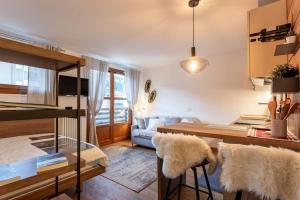 a kitchen and living room with a table and chairs at Monolocale in centro a Madesimo in Madesimo