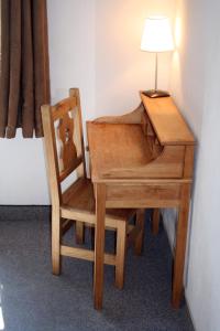 a desk and a chair with a lamp on it at Adonis Le Chastellan in Valberg