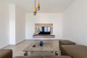 a living room with a couch and a coffee table at Villa La Domazet in Podstrana