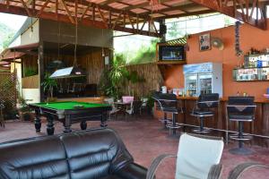 a bar with a pool table and chairs in a room at M&M Guesthouse in Ko Chang