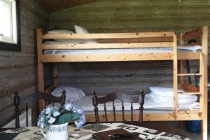 a bedroom with two bunk beds in a cabin at Ekebacken Gård & Mc-camping in Blidsberg +14 photos