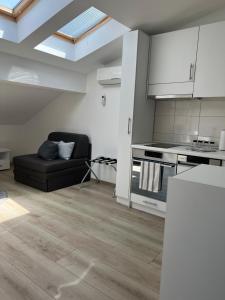 a living room with a couch and a kitchen at Apartment J.J in Požarevac