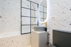 a bathroom with a sink and a tub and a window at Dreamy City Center in Bucharest +36 photos