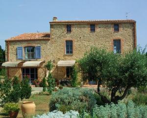 a stone house with a garden in front of it at mas la Mouillere in Camélas