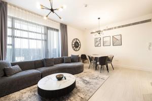 a living room with a couch and a table at 2Bedroom Private Apartment in Al Zahia, Sharjah - Stone Nest in Sharjah