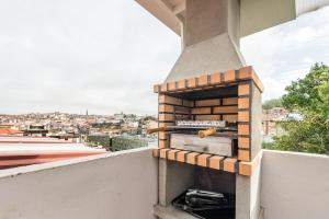 a brick oven on the side of a balcony at GuestReady - Cosy getaway in Porto in Bandeira
