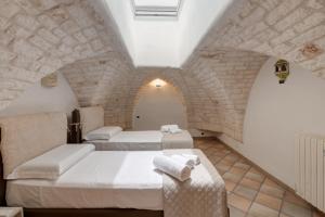 A bed or beds in a room at Dimora Gli Arcangeli