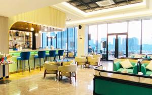 a restaurant with tables and chairs and a view of the city at SIHA Hotel & Casino in Sihanoukville