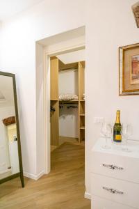 a room with a closet with wine glasses and a mirror at Residence Via Duomo in Verona +73 photos