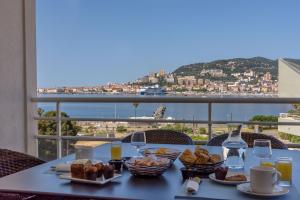 a table with food and a view of the ocean at Best Western Plus Ajaccio Amirauté in Ajaccio +37 photos