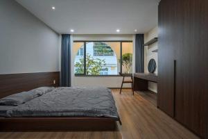 a bedroom with a bed and a large window at Sea STARS in Ho Chi Minh City