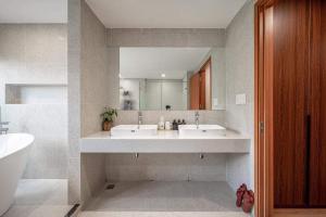 a bathroom with two sinks and a large mirror at Sea STARS in Ho Chi Minh City