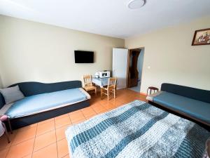 a living room with a couch and a table at Apartman Taktik in Veľký Meder