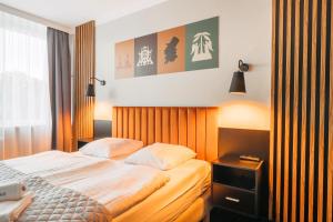 Łóżko lub łóżka w pokoju w obiekcie Hotel New Skanpol