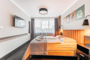 Łóżko lub łóżka w pokoju w obiekcie Hotel New Skanpol