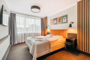Łóżko lub łóżka w pokoju w obiekcie Hotel New Skanpol