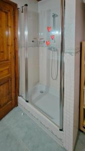a bathroom with a shower with hearts on the wall at Ço desde Viandol in Bossost +37 photos