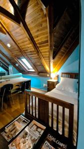 a bedroom with a bed and a table with magazines at Ço desde Viandol in Bossost