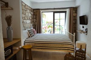 a bedroom with a bed and a window at Piraye Alaçatı in Alacati +29 photos