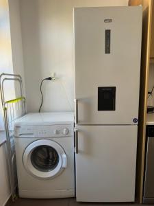 a refrigerator and a washing machine in a room at Stone Steps Studio in Symi