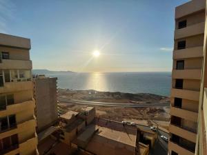 a view of the ocean from between two buildings at Frange Maritime Canastel in Bir el Djir