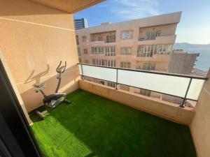 a balcony with exercise equipment on a building at Frange Maritime Canastel in Bir el Djir
