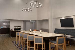 a large dining room with a large table and chairs at Hampton Inn & Suites Huntsville Research Park Area in Huntsville
