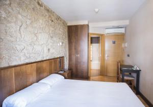 Cama o camas de una habitación en Hotel Alda Avenida