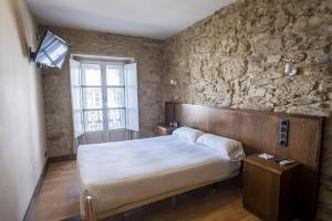Cama o camas de una habitación en Hotel Alda Avenida
