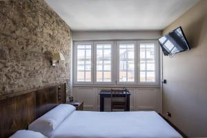 Cama o camas de una habitación en Hotel Alda Avenida