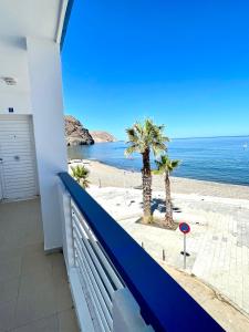 a balcony with a view of the beach at Apartamento Indalo en primera linea de playa in Las Negras