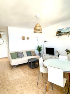 a living room with a couch and a table at Apartamento Indalo en primera linea de playa in Las Negras