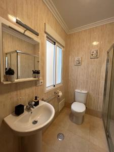 a bathroom with a sink and a toilet at Gaviota 2do in Marín +14 photos
