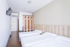 Cama o camas de una habitación en Hotel Alda Avenida