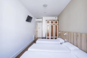 Cama o camas de una habitación en Hotel Alda Avenida