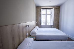 Cama o camas de una habitación en Hotel Alda Avenida