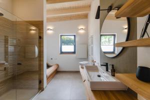 a bathroom with a sink and a shower at Birkenhof - Ferienhof, Landcafe und Rösterei in Schmallenberg +93 photos