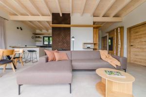 a living room with a couch and a table at Birkenhof - Ferienhof, Landcafe und Rösterei in Schmallenberg