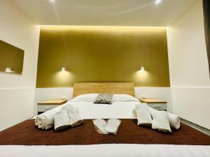 a bedroom with a large white bed with two tables at Affitta camere Marsala L'oasi delle saline in Marsala