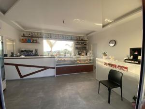 a bakery with a counter and a chair in a room at Affitta camere Marsala L'oasi delle saline in Marsala +37 photos