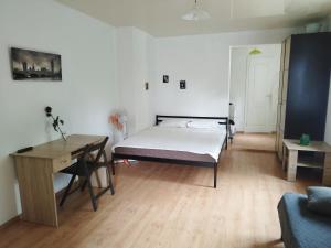 a bedroom with a bed and a table and a desk at Apartments center - Затишні апартаменти в центрі біля ЦУМа in Poltava