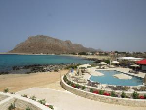 a view of a beach with a pool and the ocean at Blue Beach Villas Apartments in Stavros