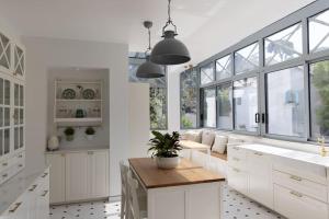 a kitchen with white cabinets and a potted plant at Beach front Villa Cap D'Antibes in Antibes