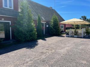 a house with trees and an umbrella in the driveway at Emmaste Teemaja in Emmaste +15 photos