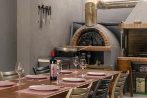 a table with glasses and a bottle of wine at Seaside Serenity Arvi in Arvi
