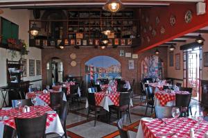 a dining room with red and white tables and chairs at Hotel Florencia Suites & Apartments in Antofagasta
