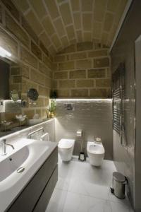 a bathroom with a sink and a toilet and a sink at Rb Suites centrale in Trapani
