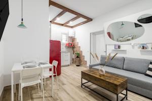 a living room with a couch and a table at Madrid Villaverde - Apartamentos acogedores, AC in Madrid